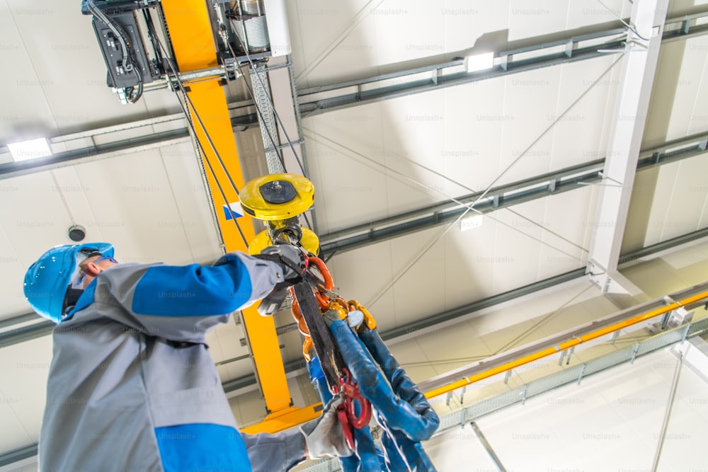 Ceiling Mounted Crane Lift Caucasian Operator. Industrial Technologies. Warehouse Lifting Equipment.