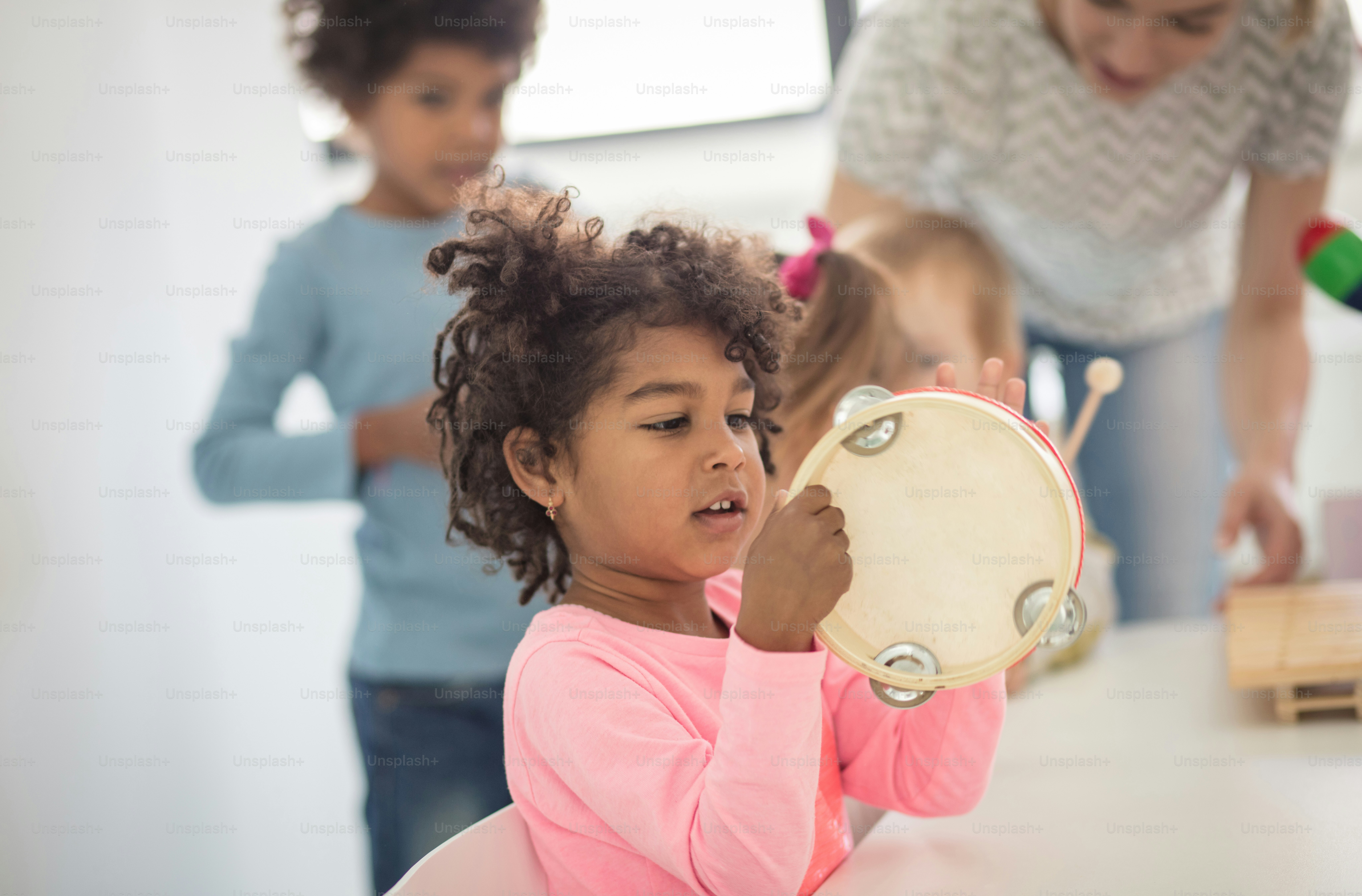 She's a tambourine girl. Child in preschool.