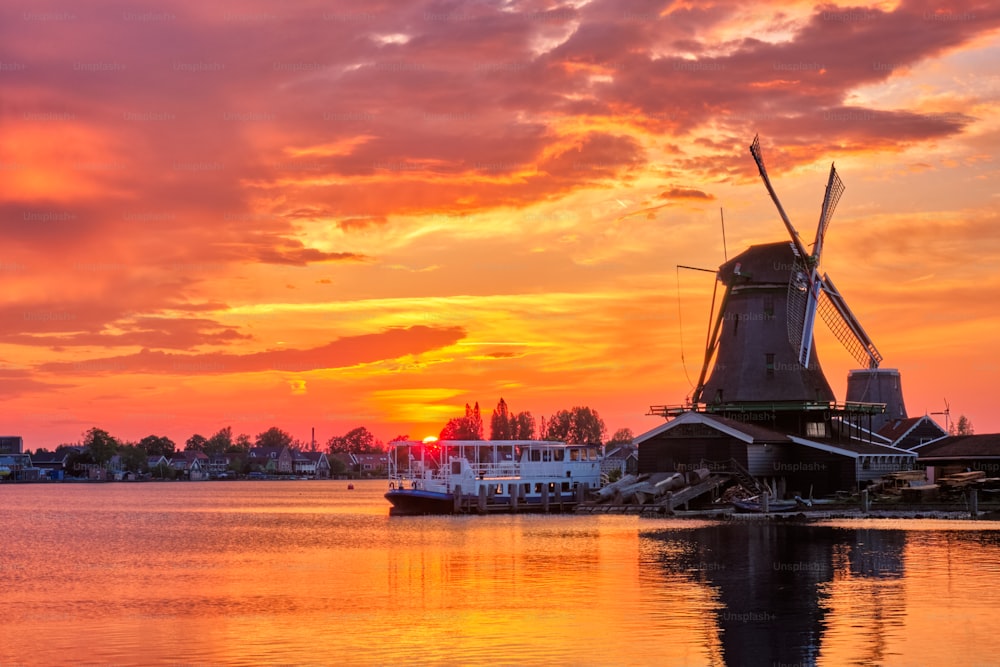 Netherlands rural scene - - windmills at famous tourist site Zaanse Schans in Holland on sunset with dramatic sky. Zaandam, Netherlands