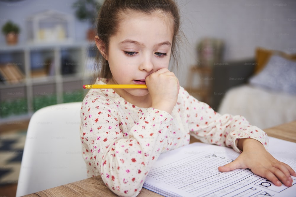 Focused girl doing her homework at home