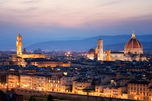 Florence Cathedral (Cattedrale di Santa Maria del Fiore) in historic center of Florence, Italy with night panoramic view of the city. Florence Cathedral is major tourist attraction of Tuscany, Italy.