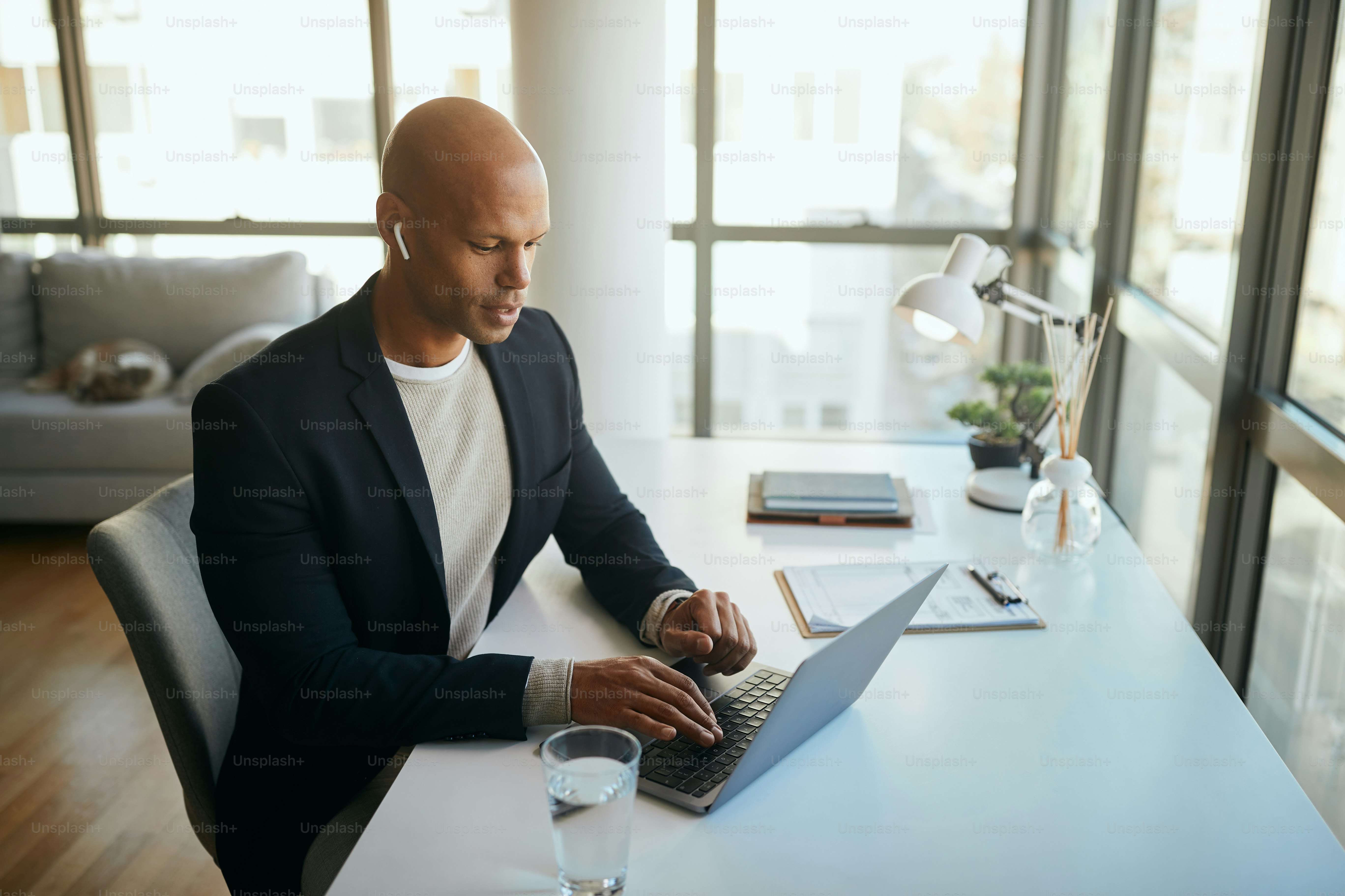 Young African American entrepreneur using computer while working in the office.