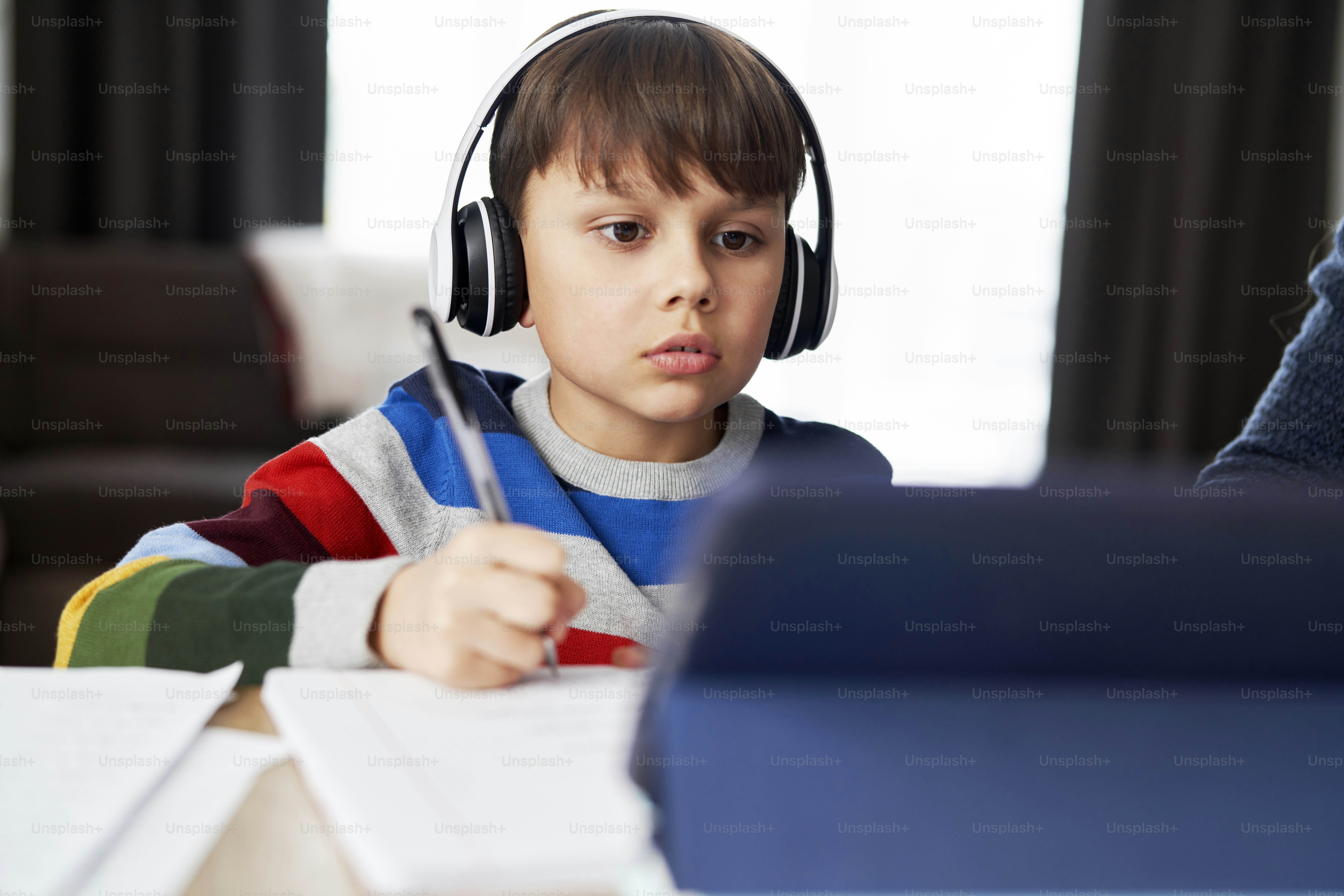 Boy in headphone during homeschooling