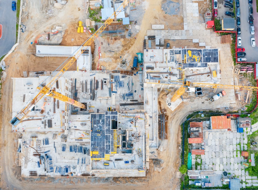 Aerial view of the beginning of the construction of the house, laying the foundation. Construction crane. View from above exactly