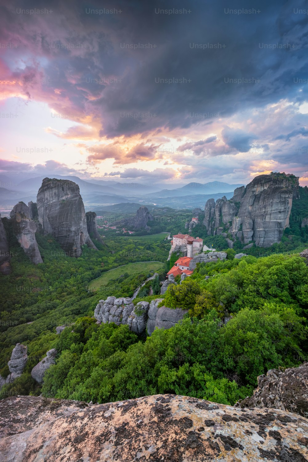 Sunset sky and monastery of Rousanou and Monastery of St. Nicholas Anapavsa in famous greek tourist destination Meteora in Greece with dramatic sky