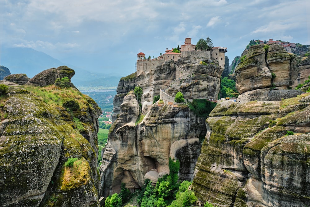Monastery of Varlaam and Monastery of Great Meteoron in famous greek tourist destination Meteora in Greece on sunset with scenic scenery landscape