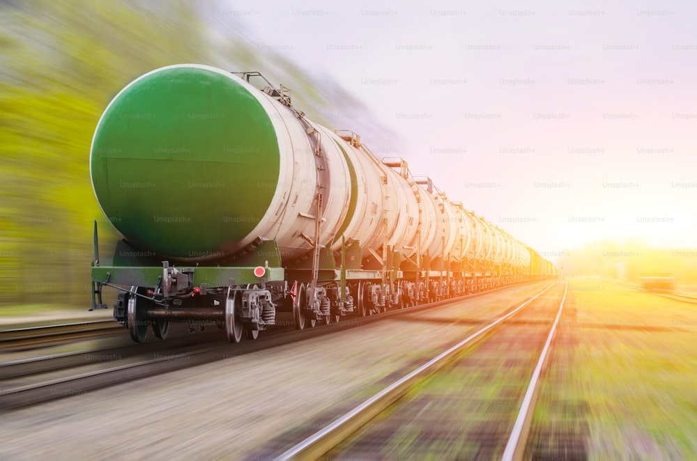 Freight train passing oil-loading, fuel oil, fuel tanks in motion