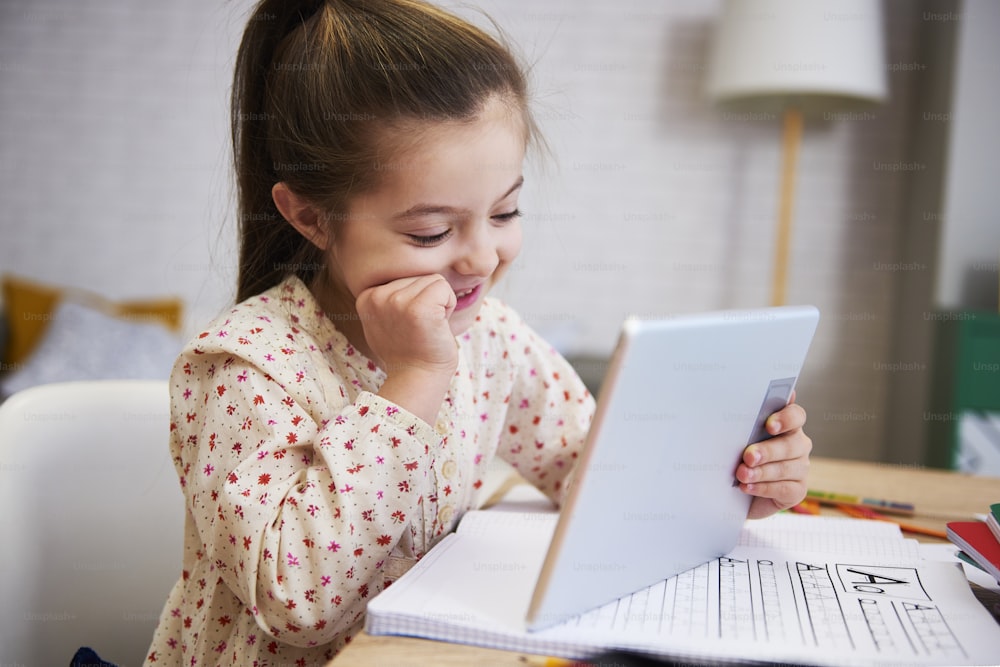 Girl learning with technology at home
