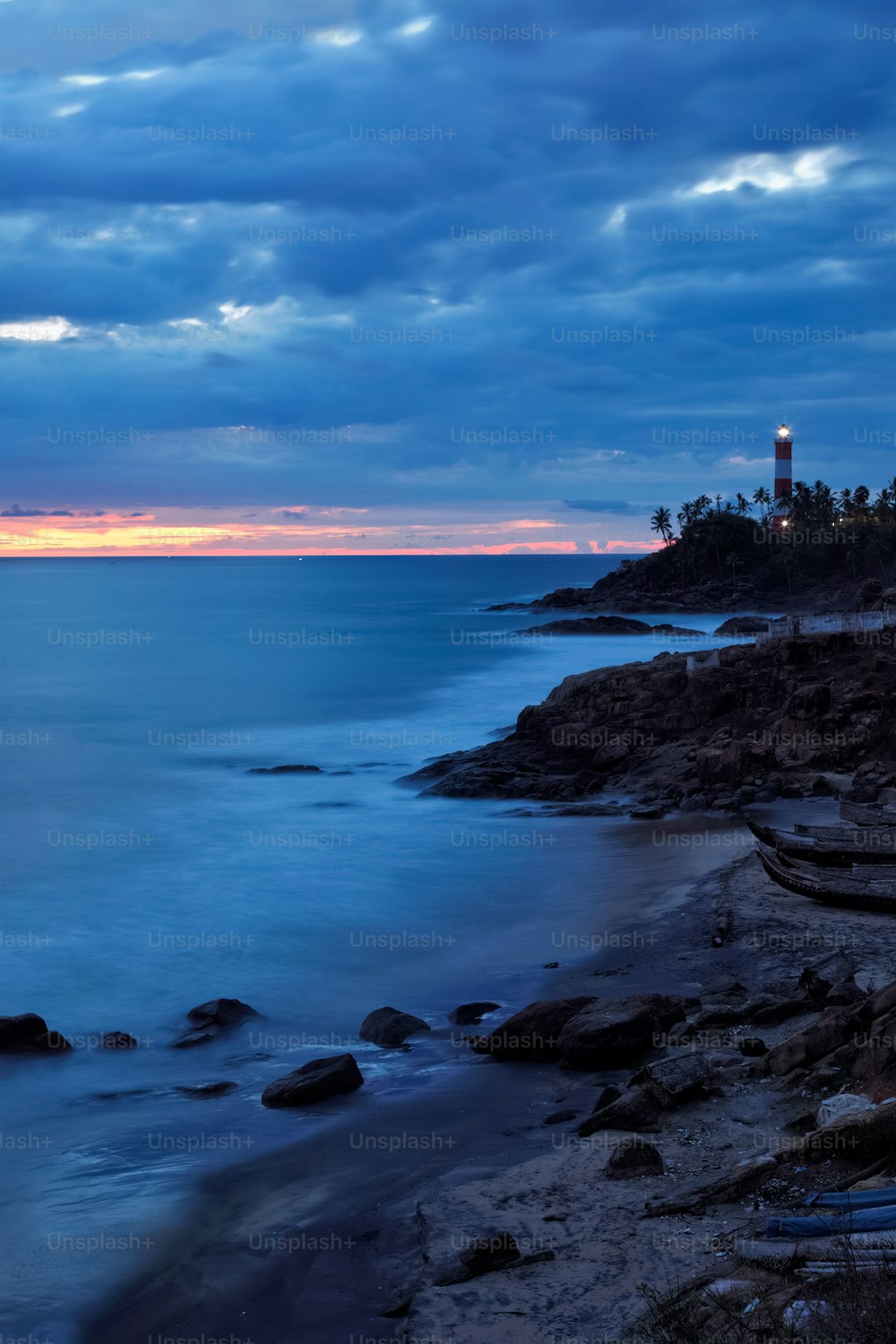 Kovalam Vizhinjam lighthouse on beautiful Arabian sea coast during sunset. Icredible India concept. Kerala, India