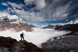 Hiker is climbig to Manaslu base camp in highlands of Himalayas on Manaslu circuit