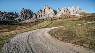 Dirt road and hiking trail track in Dolomites mountain, Italy, in front of Pizes de Cir Ridge mountain ranges in Bolzano, South Tyrol, Northwestern Dolomites, Italy.