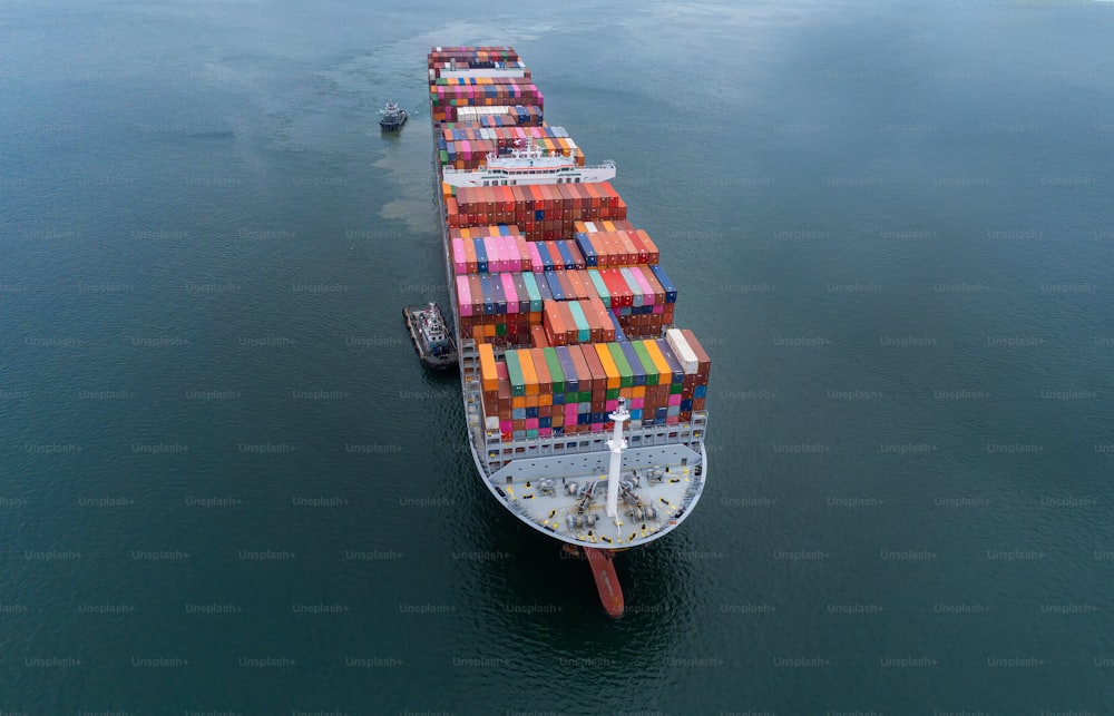 Aerial top view containers ship cargo business commercial trade logistic and transportation of international import export by container freight cargo ship in the open seaport.