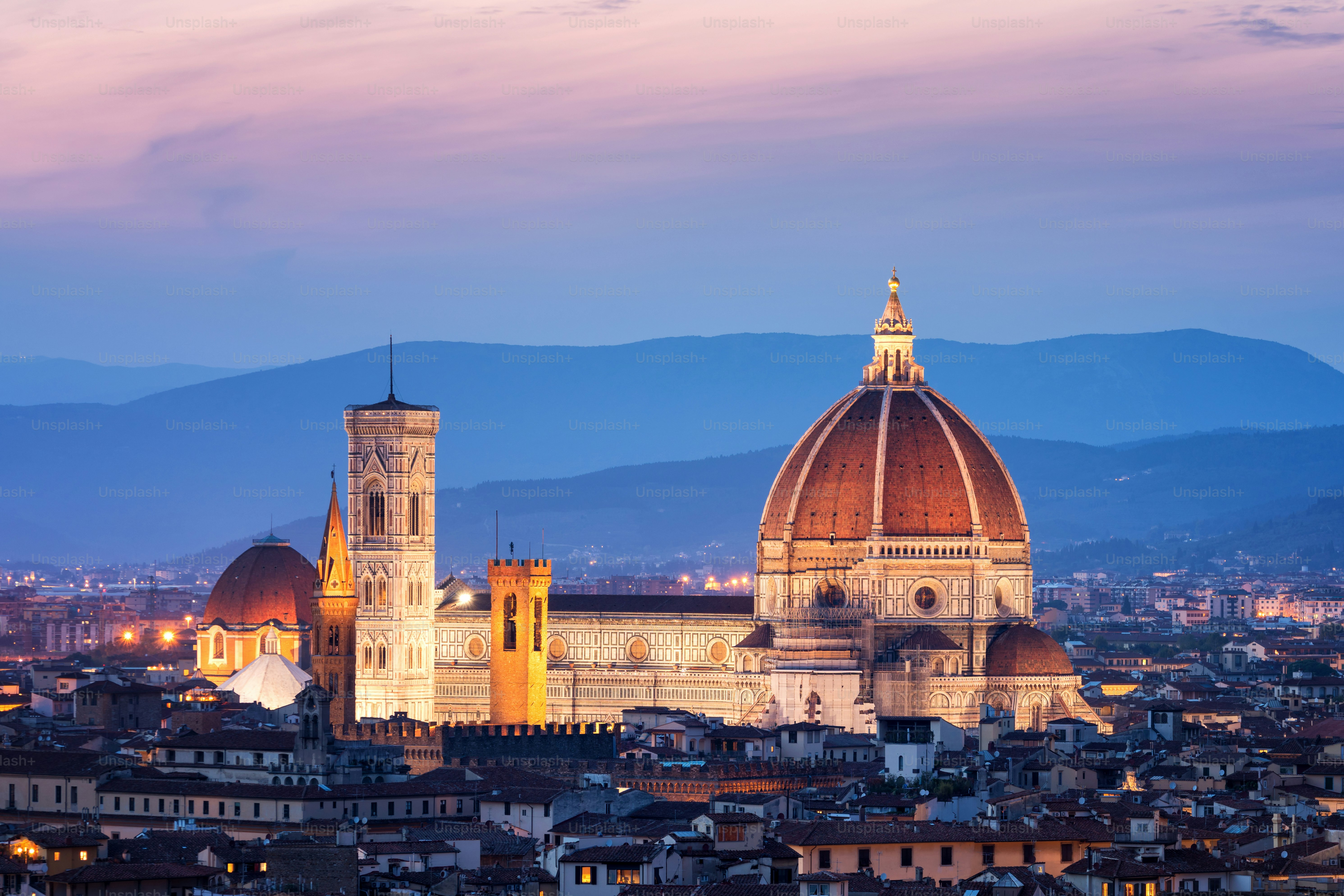 Florence Cathedral (Cattedrale di Santa Maria del Fiore) in historic center of Florence, Italy with night panoramic view of the city. Florence Cathedral is major tourist attraction of Tuscany, Italy.
