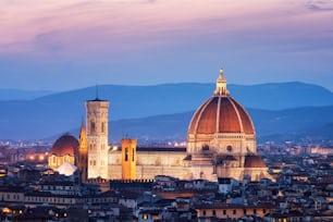 Florence Cathedral (Cattedrale di Santa Maria del Fiore) in historic center of Florence, Italy with night panoramic view of the city. Florence Cathedral is major tourist attraction of Tuscany, Italy.