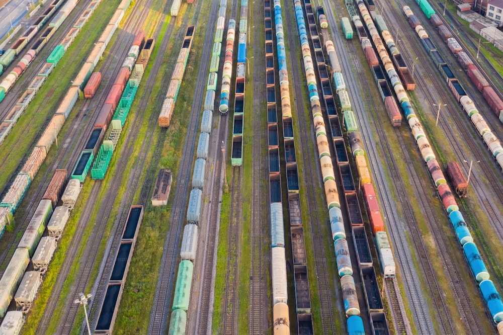 Aerial perspective view of railroad tracks, cargo sorting station. Many different railway cars with cargo and raw materials