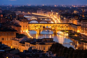 Florence Ponte Vecchio Bridge at Night Skyline in Italy. Florence is capital city of the Tuscany region of central Italy. Florence was center of Italy medieval trade and wealthiest cities of past era.