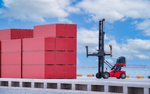 Forklift truck is lifting cargo containers at a seaport waiting for distribution terminal goods to aboard are import and export logistic transportation shipment business concept.