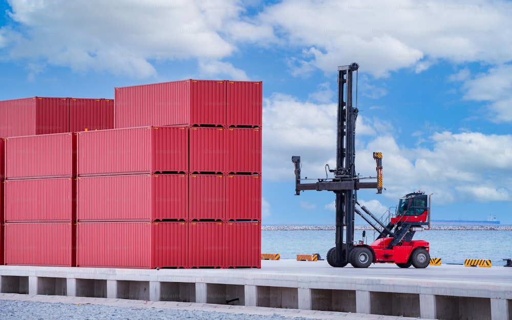 Forklift truck is lifting cargo containers at a seaport waiting for distribution terminal goods to aboard are import and export logistic transportation shipment business concept.