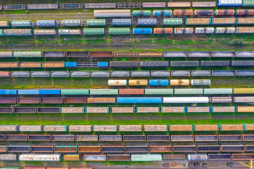 Top view of cargo railway carriage. Aerial view from flying drone of colorful freight trains on the railway sort facility. Wagons with goods on railroad. Heavy industry, industrial conceptual scene