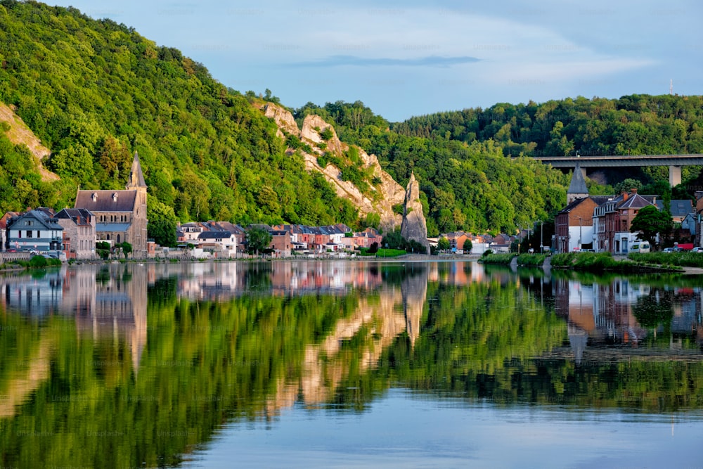 View of picturesque Dinant city over the Meuse river Dinant is a Walloon city and municipality located on the River Meuse, in the Belgian province of Namur on sunset with Bayard Rock and highway