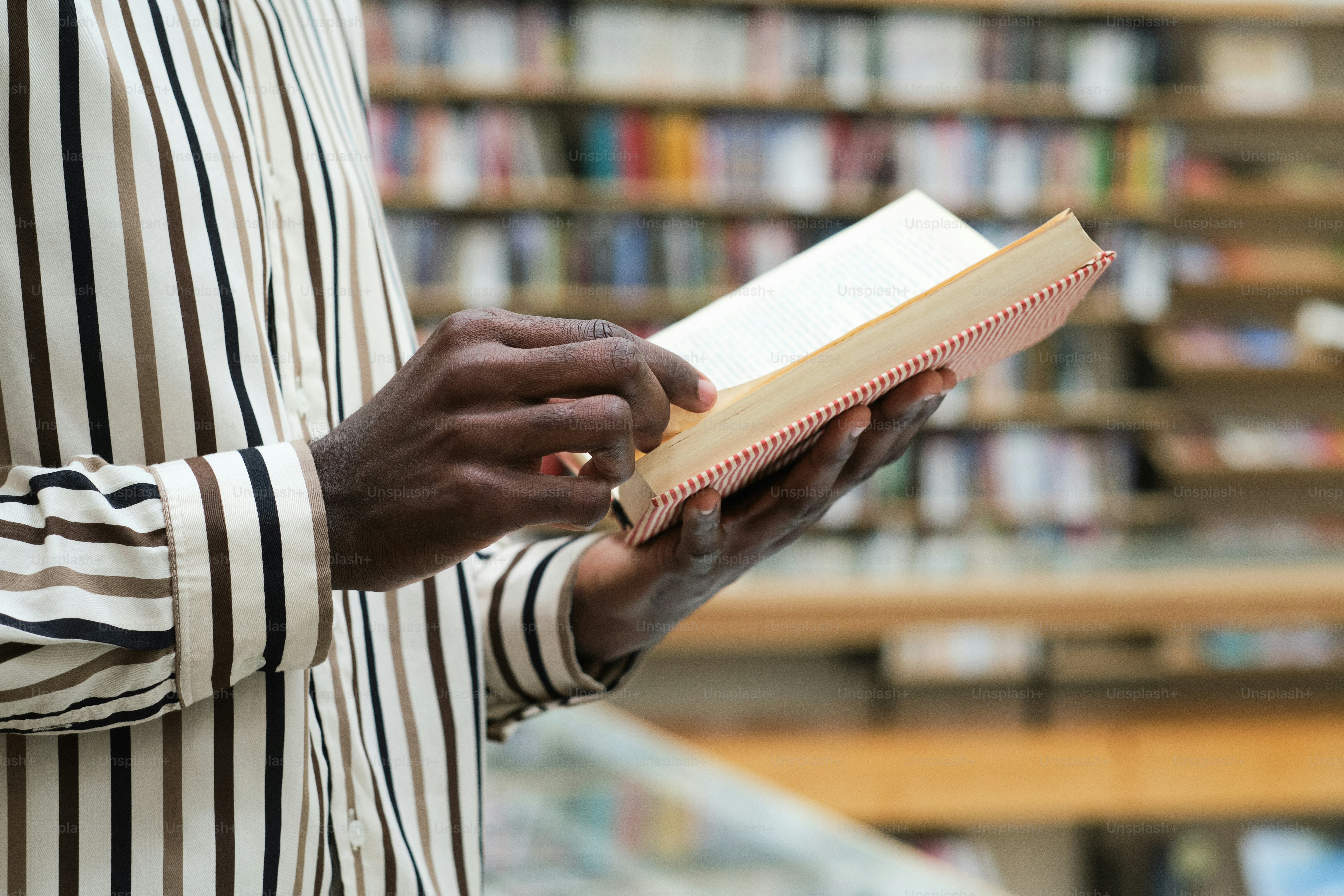 Close-up of African man holding book in his hands and reading