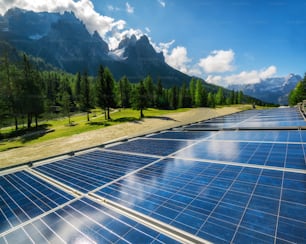 Solar cell panel in country landscape against sunny sky and mountain backgrounds. Solar power is the innovation for sustainability of world energy. Sustainable resources.