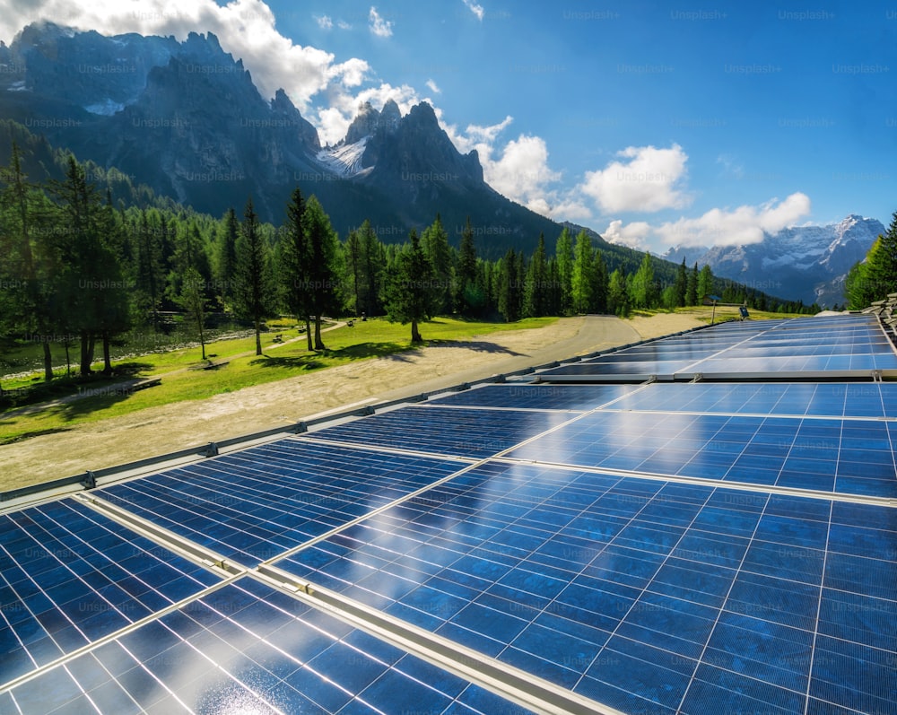 Solar cell panel in country landscape against sunny sky and mountain backgrounds. Solar power is the innovation for sustainability of world energy. Sustainable resources.