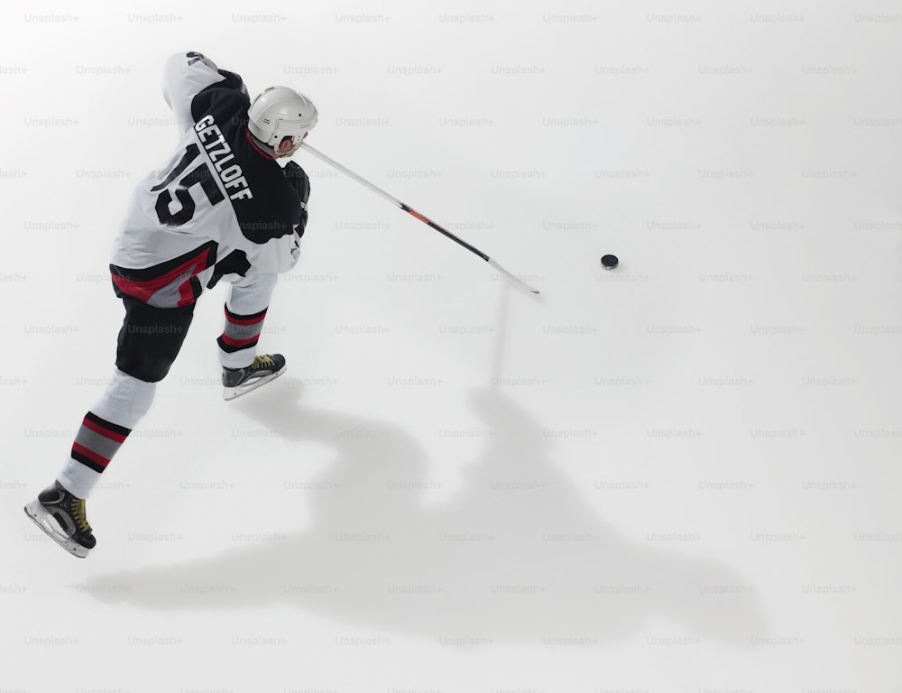 a man in a black and white uniform is playing ice hockey