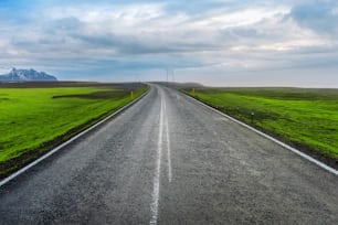 A long straight road and blue sky.