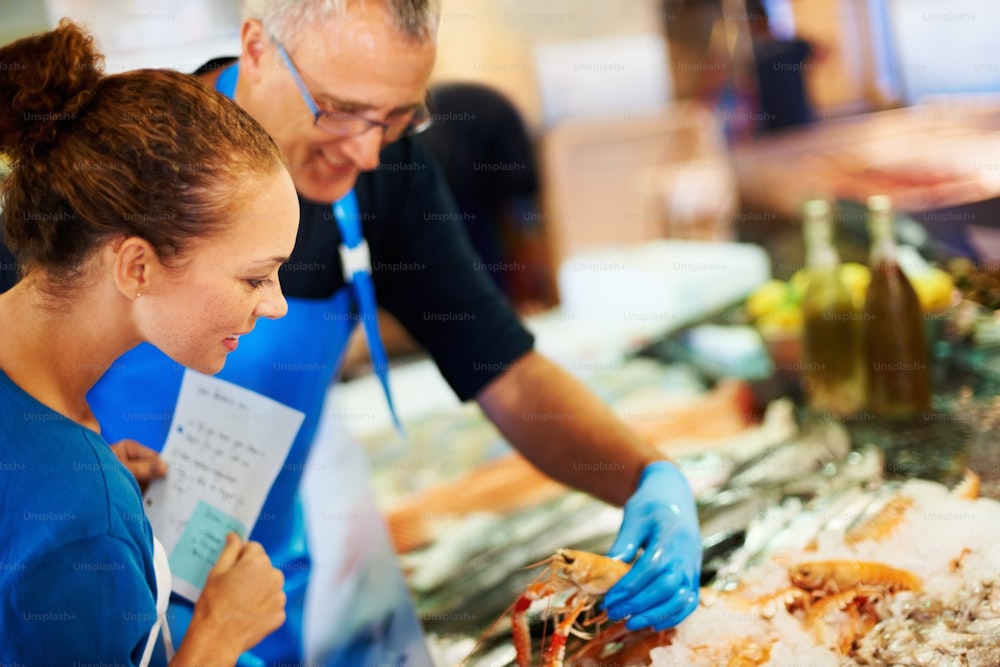 a man and a woman are preparing food