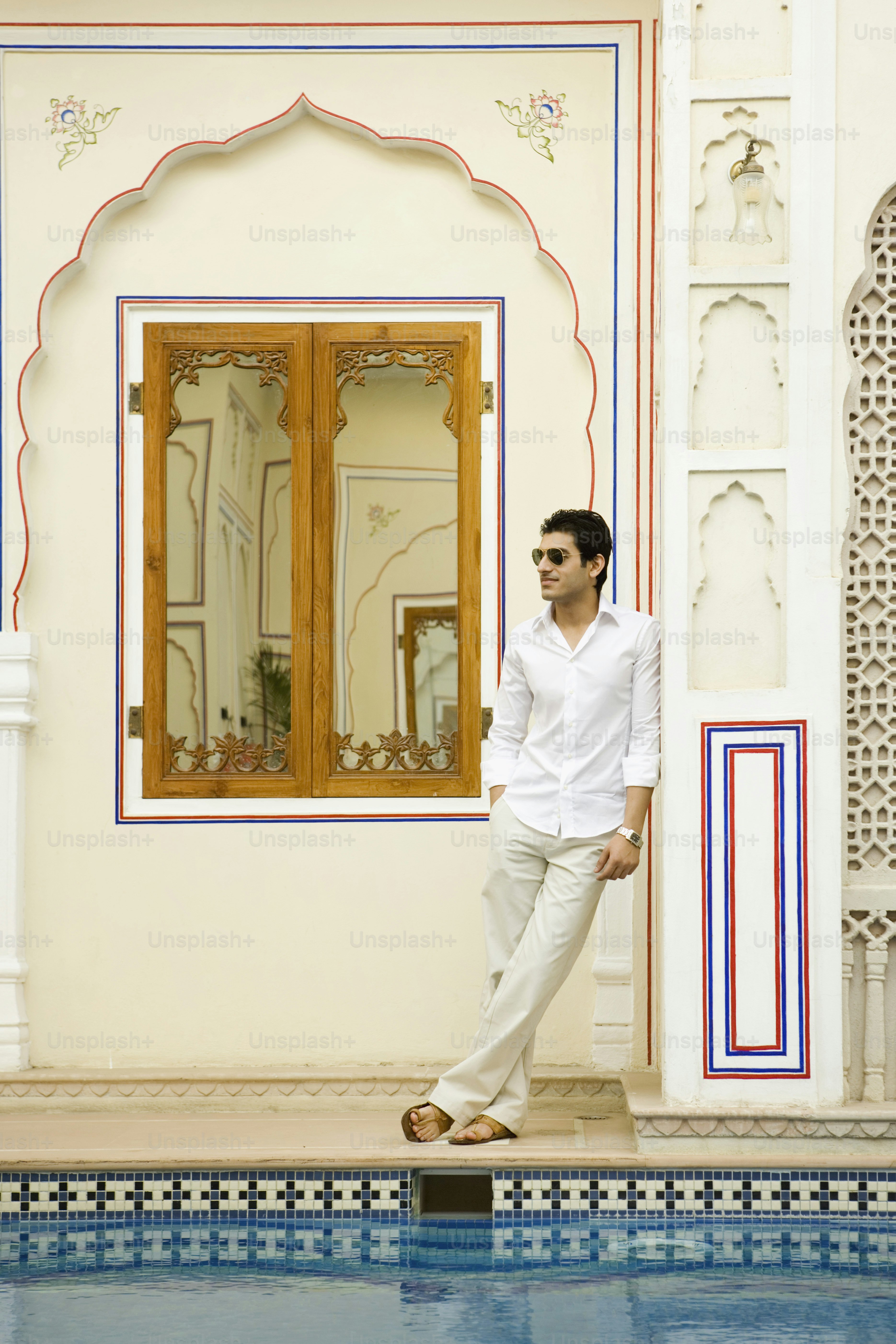 a man standing in front of a swimming pool