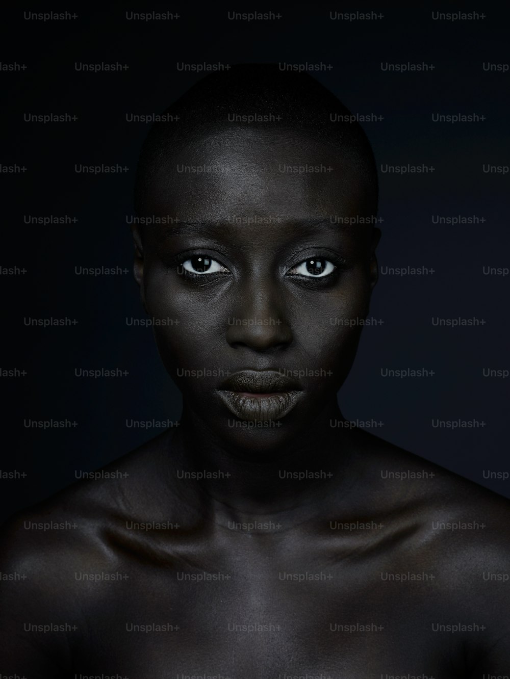 a woman with dark skin and blue eyes