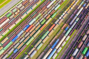 Cargo railway carriage. Colorful freight trains on the railway sort facility. Wagons with goods on railroad. Heavy industry, industrial scene