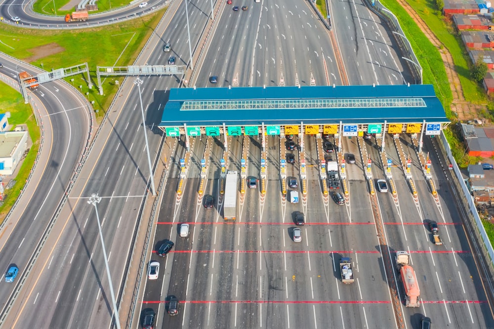 Top view aerial overloaded toll road or tollway on the controlled access highway, forced traffic jam