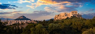 Panorama of famous greek tourist landmark - the iconic Parthenon Temple at the Acropolis of Athens as seen from Philopappos Hill on sunset. Athens, Greece