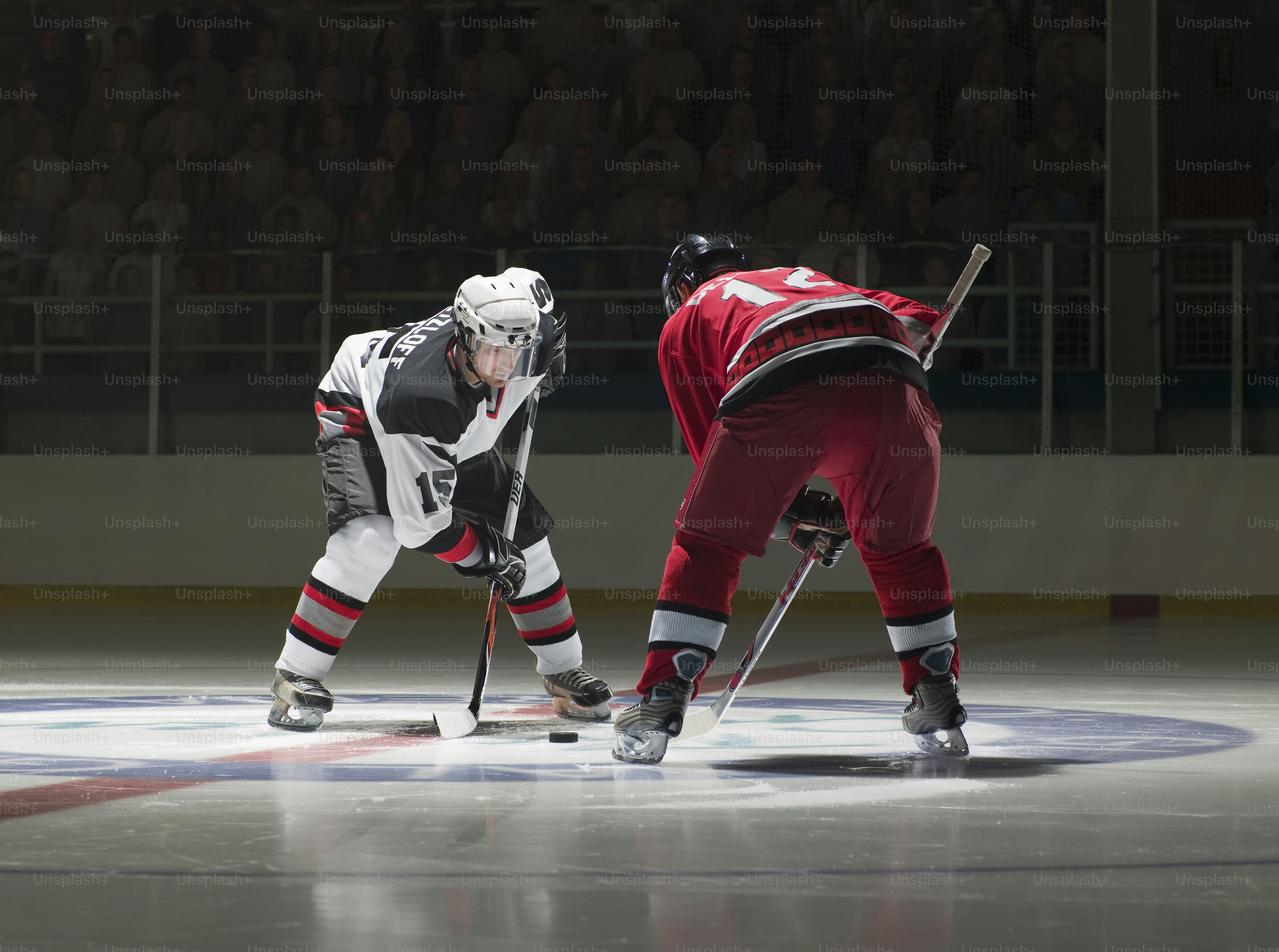 a couple of men playing a game of ice hockey