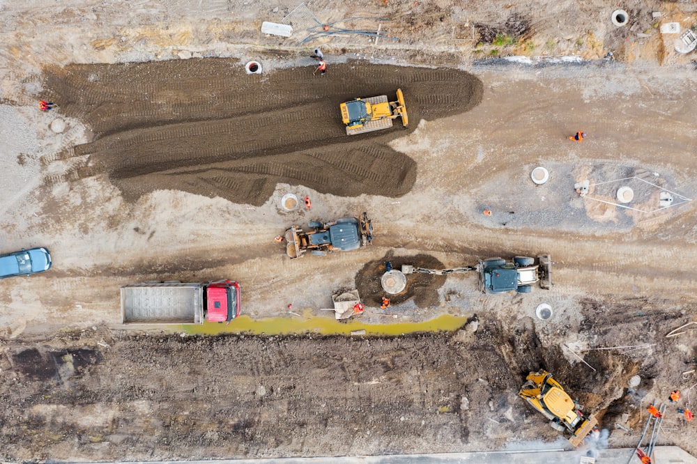 Construction of a city street, laying of communications, installation of sewer hatches, gutters, curbs. Preparation for paving, aerial view