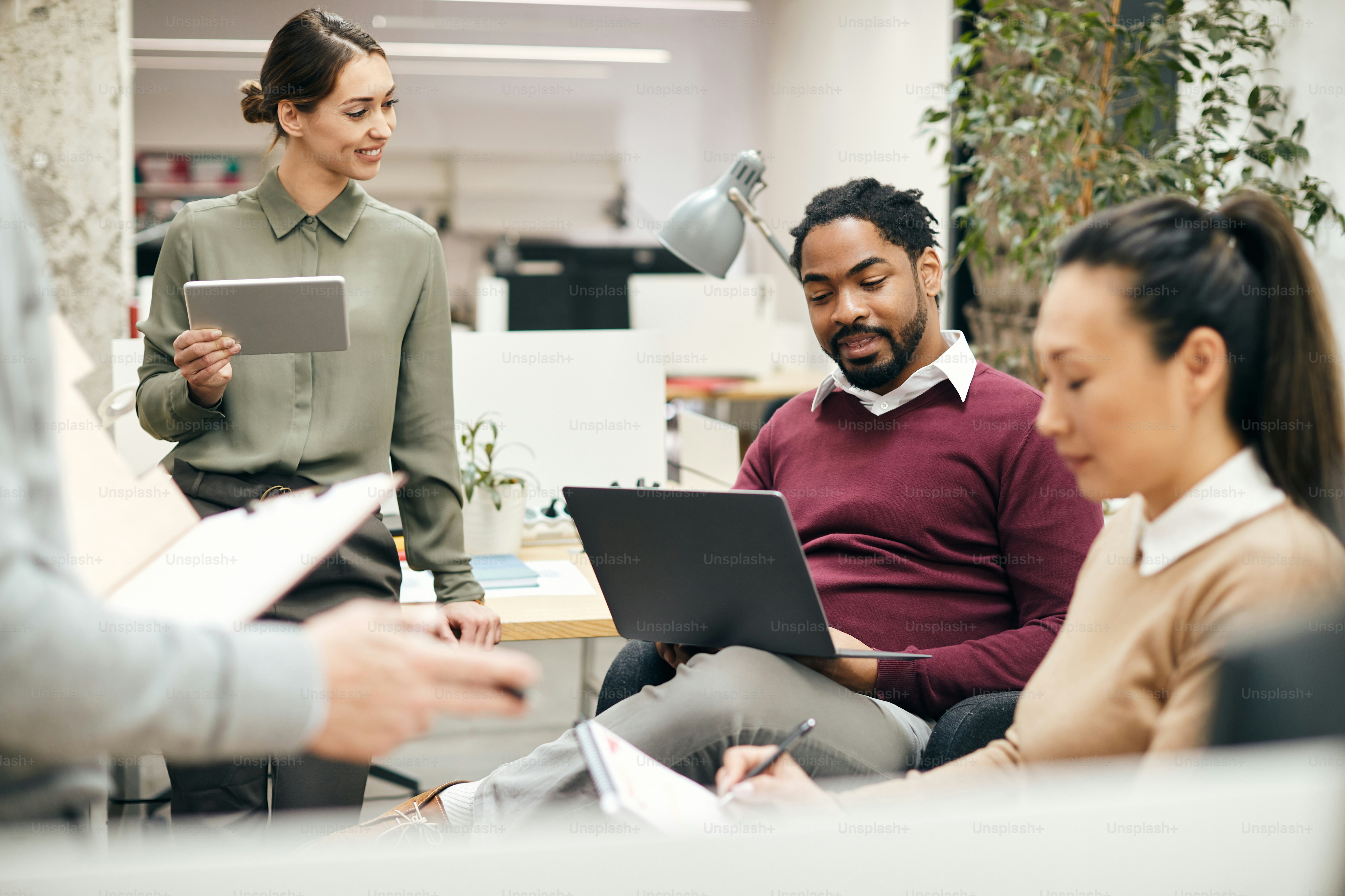Group of diverse colleagues working on business meeting at corporate office.