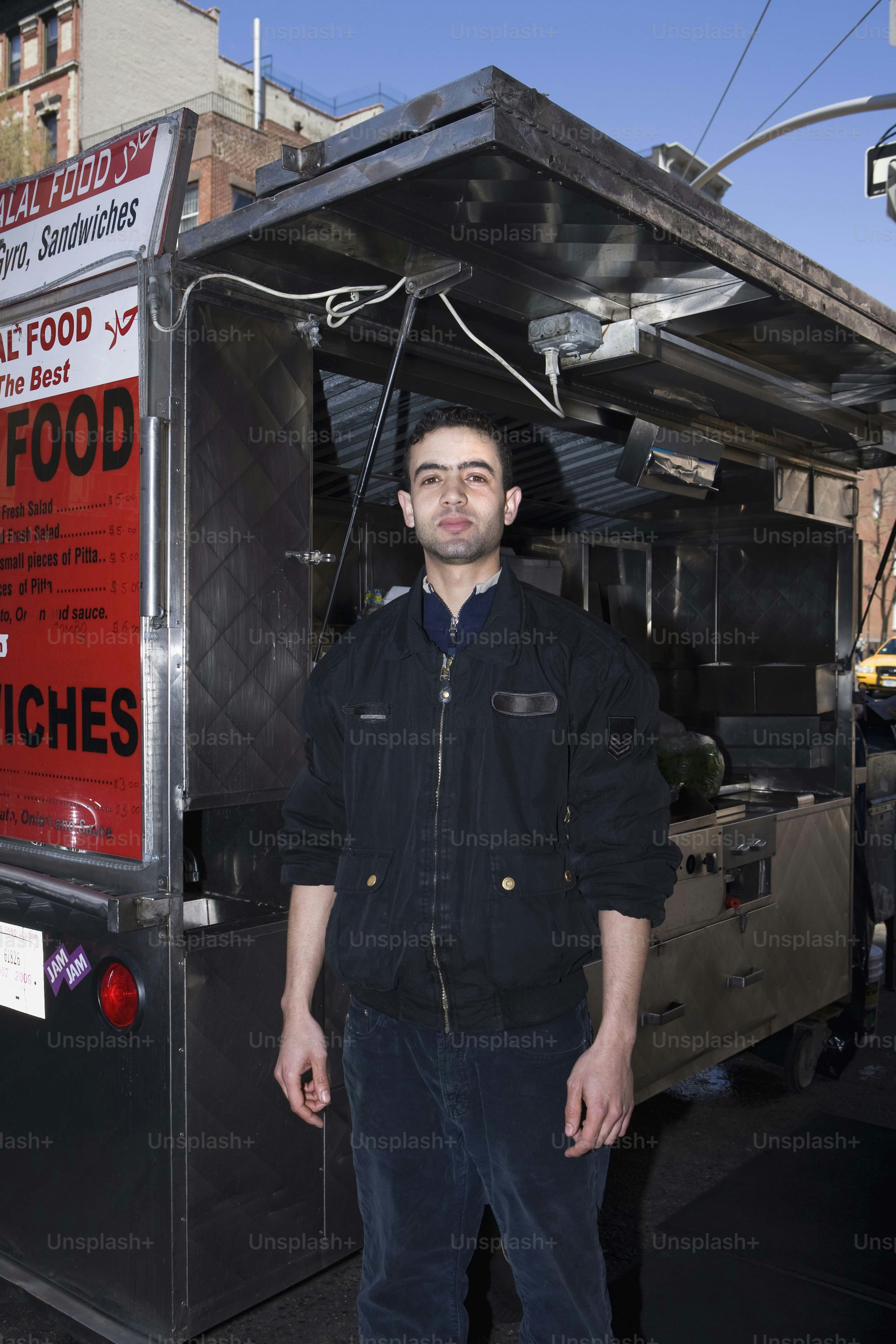 a man standing in front of a food truck