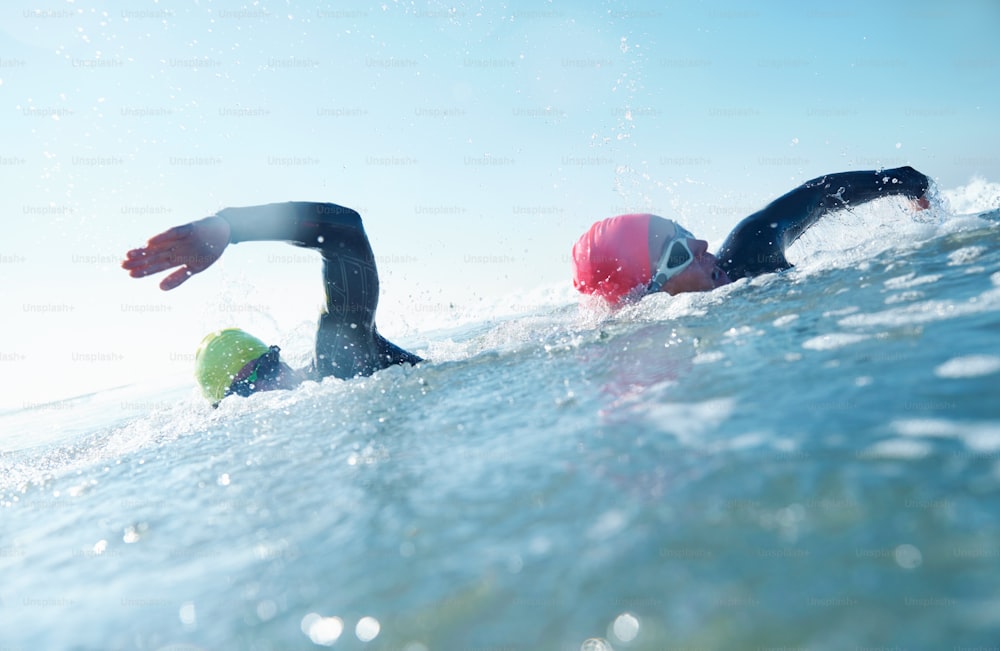Two athletes competing in a triathlon