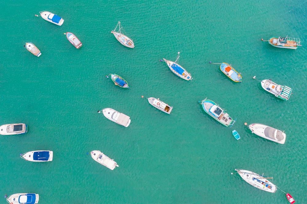 Traditional eyed colorful boats in the harbor of Mediterranean fishing village, aerial view Marsaxlokk, Malta