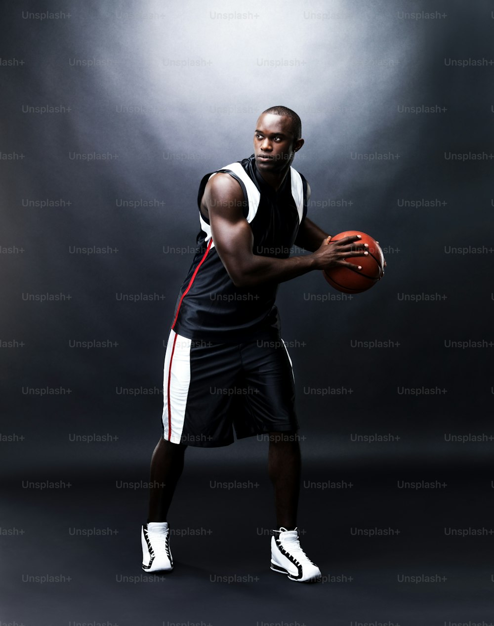 a man holding a basketball in his right hand