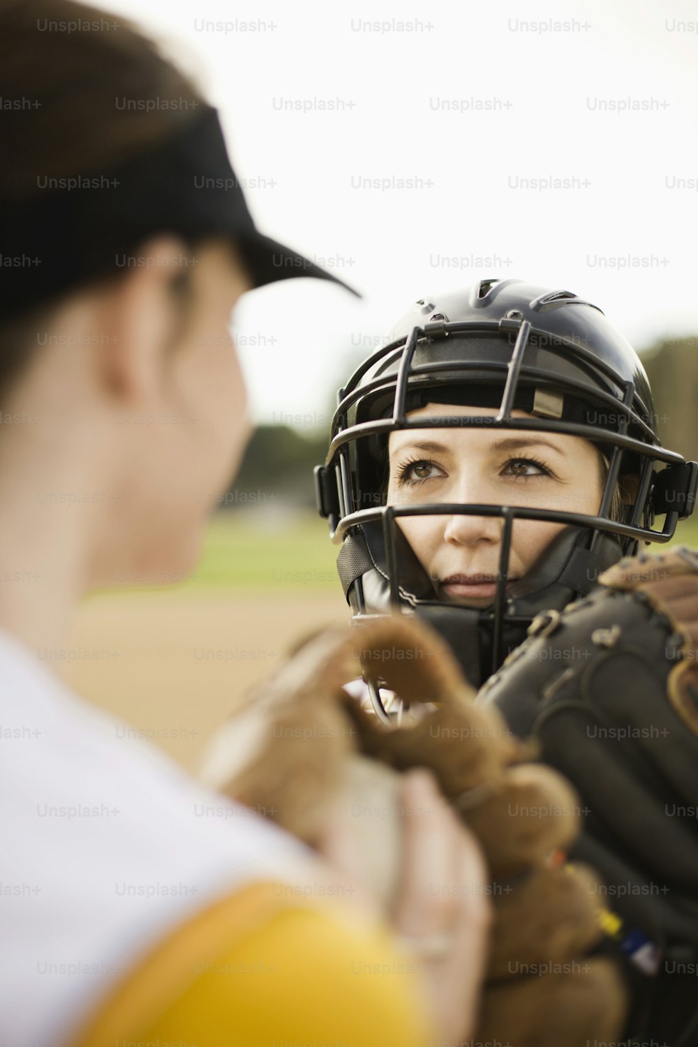a woman wearing a catchers mitt and a catchers mitt