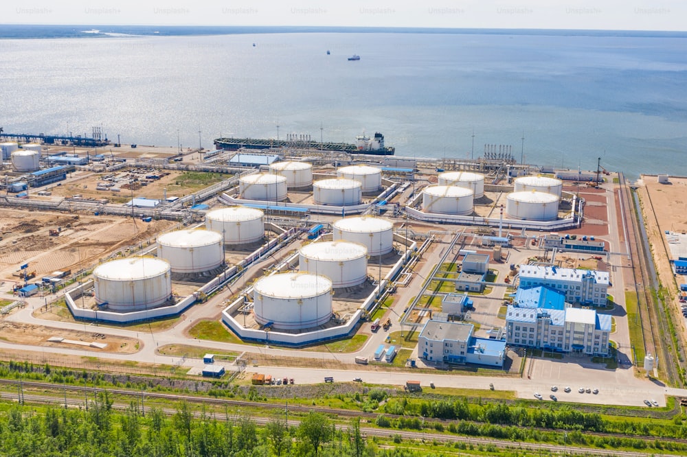 Business commercial trade fuel and energy transport by tanker vessel. Aerial view storage tank farm at night, Tank farm storage chemical petroleum petrochemical refinery product at oil terminal