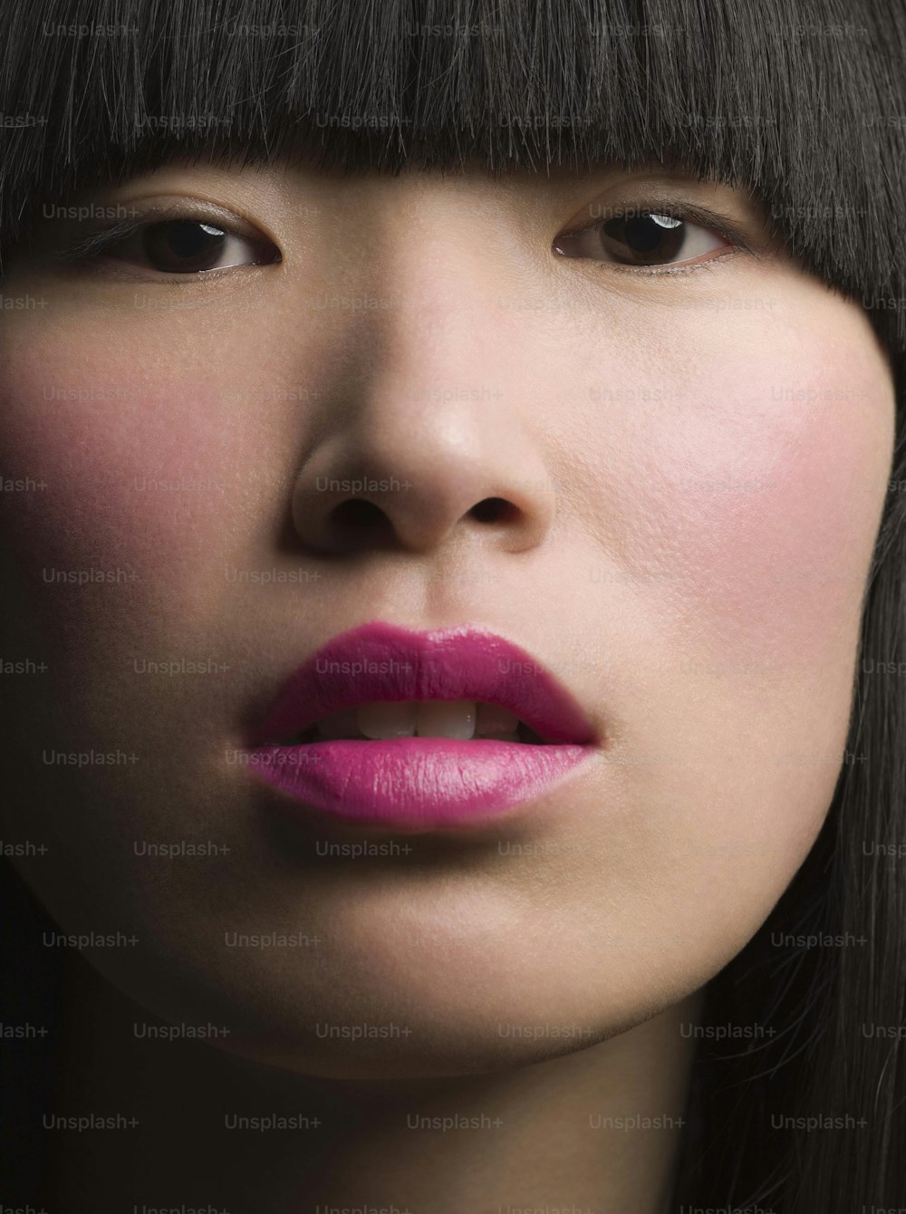 a close up of a person with a pink lipstick