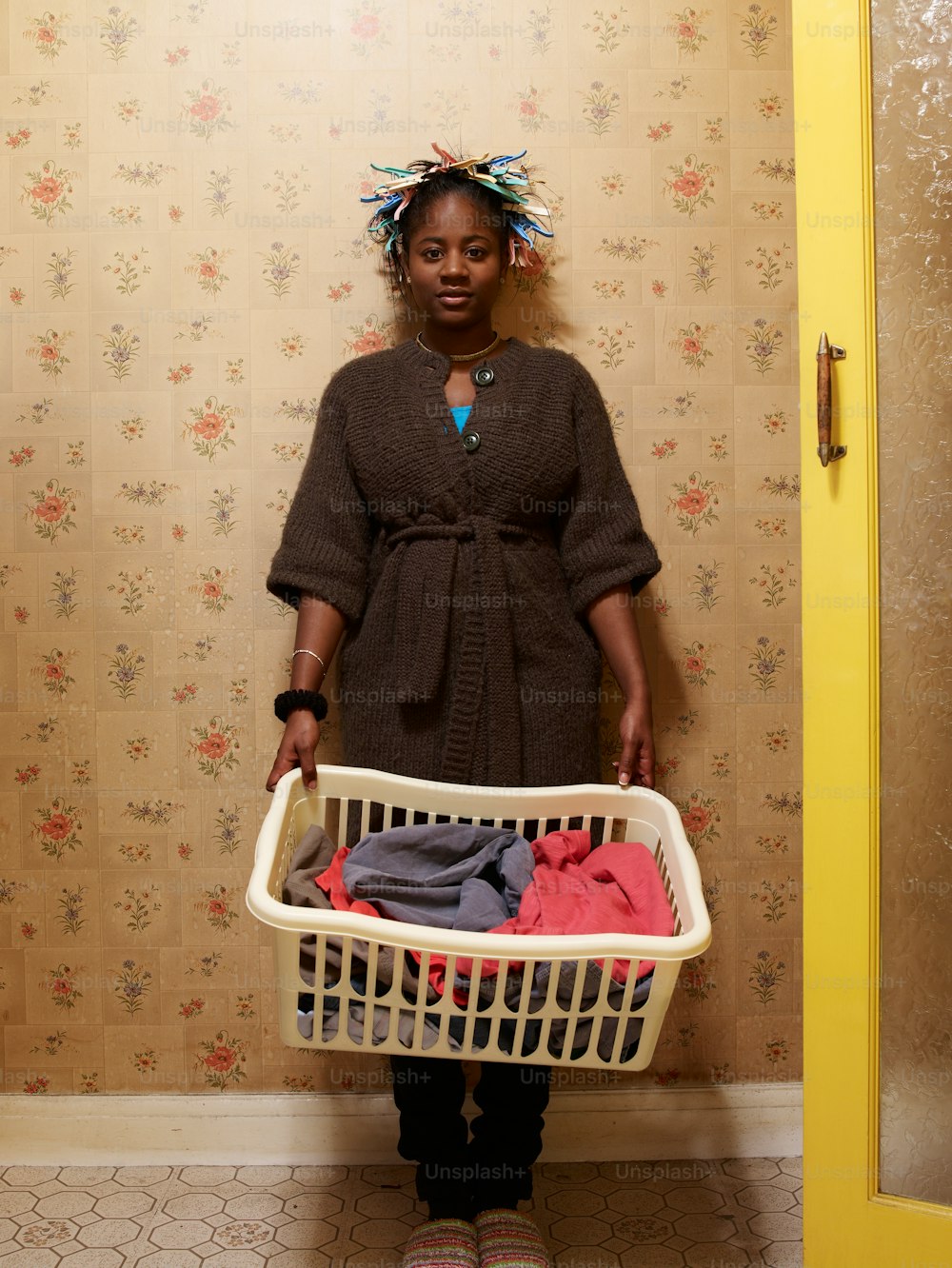 a woman holding a basket full of clothes