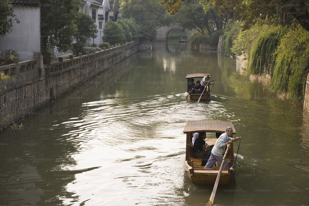 a couple of small boats traveling down a river