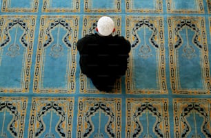 ISTANBUL, TURKEY- FEBRUARY 26:  Turkish men kneel for prayers in a mosque February 26, 2003 in Istanbul, Turkey. Turkey, a secular democracy, is overwhelmingly Muslim and public opinion is steadfastly against an American-led war in Iraq. Turkey's parliament will consider allowing U.S. troops into the country February 27.