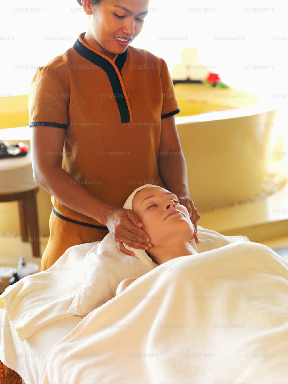 a woman getting a facial massage on her face