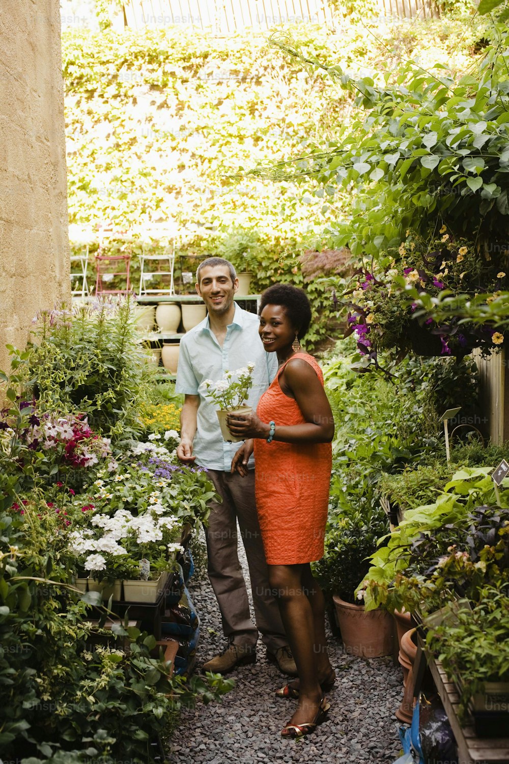 a man and a woman standing in a garden